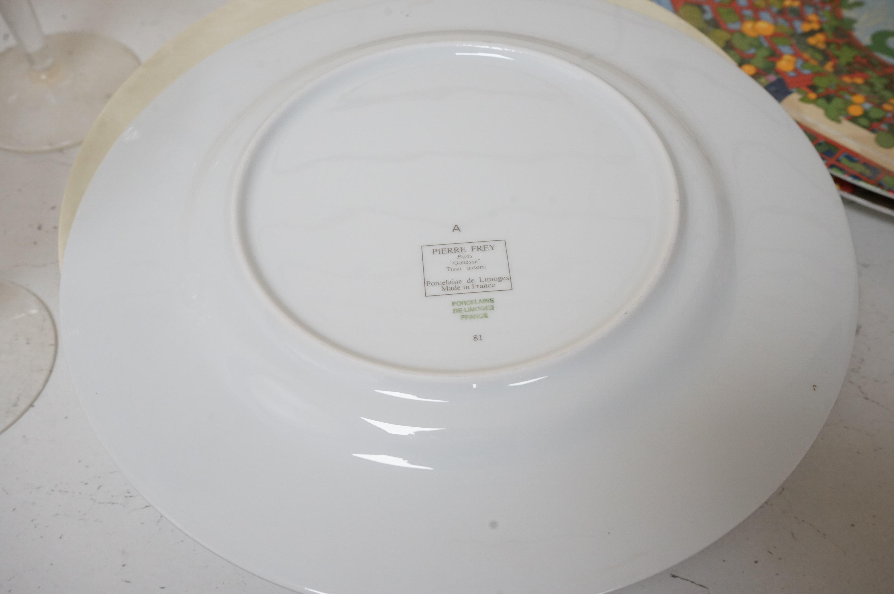 A Pierre Frey ‘Gonesse’ Limoges part dinner service, two Villeroy and Boch ‘Jardins Francais’ dinner plates, with a collection of Riedel wine glasses and mixed Salviati champagne glasses. Villeroy and Boch plates 30.5cm
